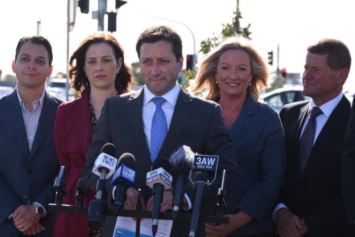 Matthew Guy campaigns in Bentleigh Matthew Guy speaks to reporters in front of a traffic intersection, flanked by his wife and three Liberal candidates.